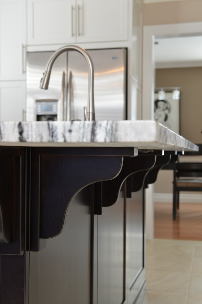 Inspiration for a large transitional u-shaped ceramic tile enclosed kitchen remodel in Toronto with an undermount sink, stainless steel appliances, dark wood cabinets, granite countertops, beige backsplash, matchstick tile backsplash, an island and flat-panel cabinets