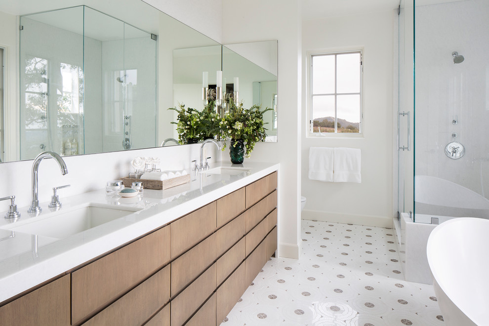 This is an example of a mid-sized contemporary master bathroom in Santa Barbara with flat-panel cabinets, medium wood cabinets, white walls, an undermount sink, an alcove shower, a two-piece toilet, porcelain floors, engineered quartz benchtops and a hinged shower door.