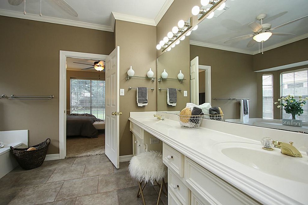 Example of a large transitional master ceramic tile and gray floor alcove bathtub design in Houston with beaded inset cabinets, white cabinets, brown walls, an integrated sink and quartz countertops