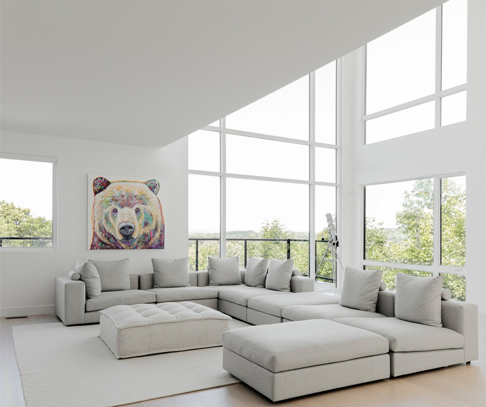 Inspiration for a contemporary open concept living room in Montreal with white walls, light hardwood floors, no tv and beige floor.