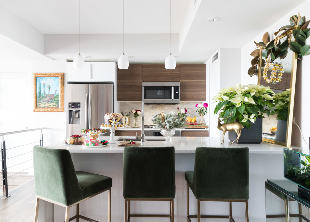 Inspiration for an eclectic u-shaped kitchen in Chicago with an undermount sink, flat-panel cabinets, dark wood cabinets, beige splashback, stainless steel appliances, dark hardwood floors, a peninsula, brown floor and white benchtop.