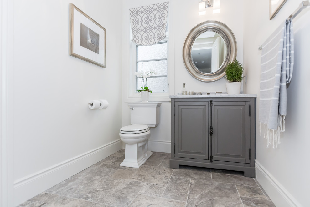 Small transitional 3/4 bathroom in Toronto with furniture-like cabinets, grey cabinets, a one-piece toilet, white tile, white walls, marble floors, an undermount sink, marble benchtops and grey floor.