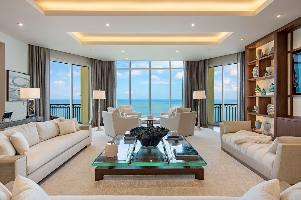 This is an example of a beach style formal open concept living room in Raleigh with beige walls, dark hardwood floors, a built-in media wall and brown floor.