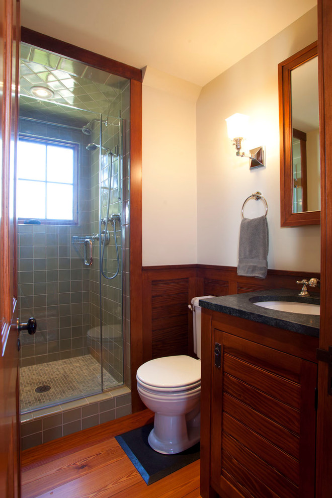 Mid-sized traditional bathroom in Boston with recessed-panel cabinets, dark wood cabinets, an alcove shower, a two-piece toilet, green tile, ceramic tile, white walls, medium hardwood floors, an undermount sink and soapstone benchtops.
