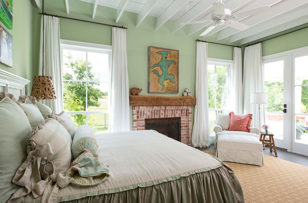 Design ideas for a country bedroom in Dallas with green walls, a standard fireplace and a brick fireplace surround.