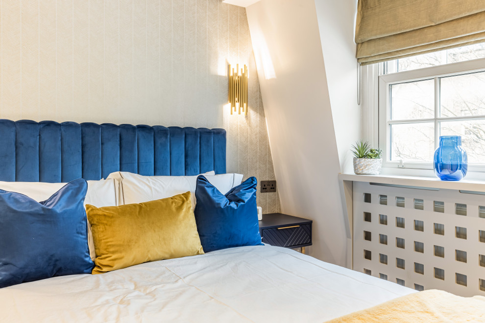 Inspiration for a medium sized contemporary guest loft bedroom in London with blue walls, painted wood flooring, a drop ceiling and wallpapered walls.