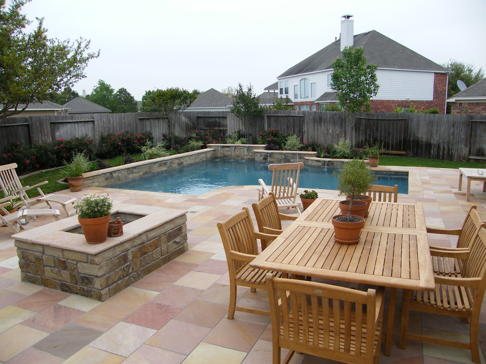 Inspiration for a mid-sized transitional backyard tile and custom-shaped pool fountain remodel in Houston