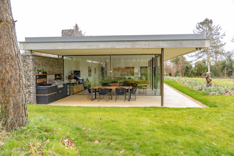 Photo of a small contemporary patio in Other with an outdoor kitchen and a roof extension.