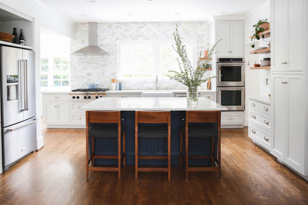 Inspiration for a mid-sized transitional u-shaped dark wood floor and brown floor eat-in kitchen remodel in Portland with a farmhouse sink, shaker cabinets, gray cabinets, quartz countertops, white backsplash, marble backsplash, stainless steel appliances, an island and white countertops