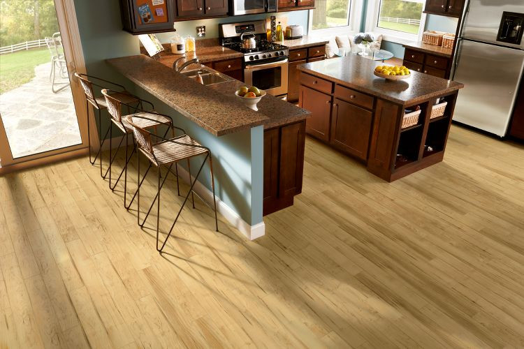 Kitchen - light wood floor and beige floor kitchen idea in Chicago with stainless steel appliances and an island