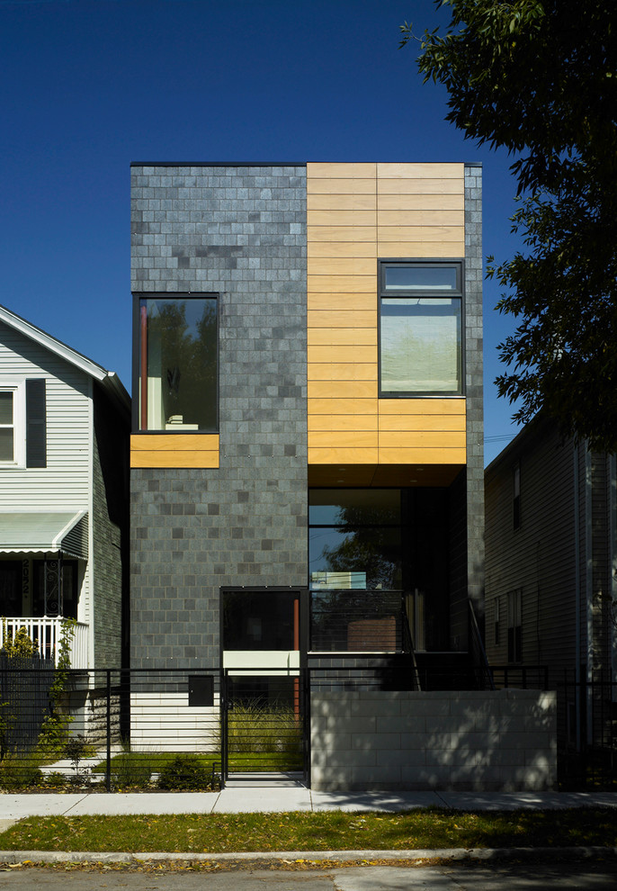 Photo of a mid-sized modern three-storey brick black exterior in Chicago.