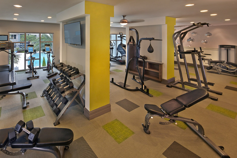 Inspiration for a large transitional home weight room in Tampa with beige walls.