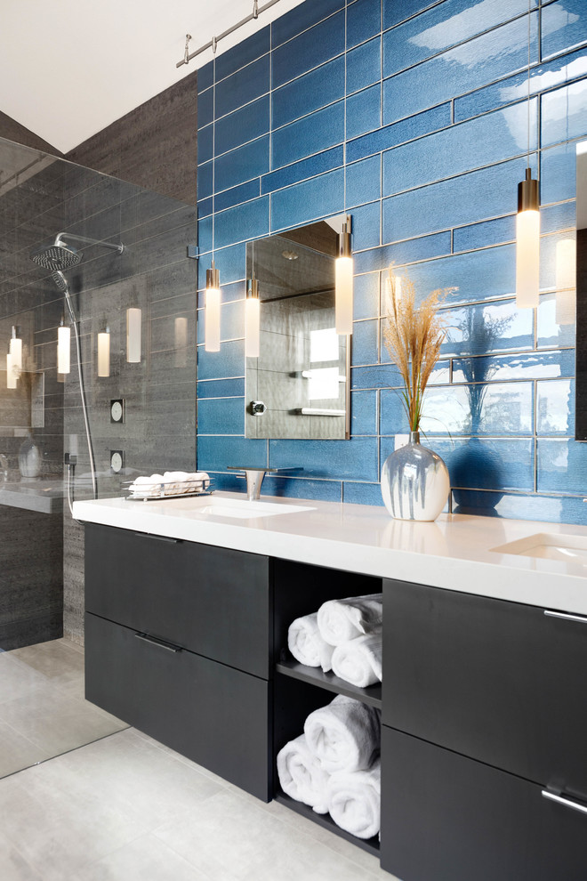 Photo of a large contemporary master bathroom in Seattle with flat-panel cabinets, black cabinets, a freestanding tub, a curbless shower, gray tile, porcelain tile, grey walls, porcelain floors, an undermount sink, engineered quartz benchtops, grey floor, an open shower and white benchtops.