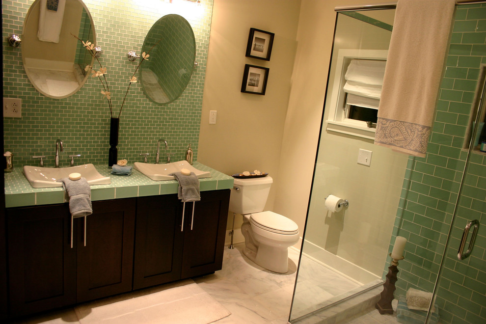 This is an example of a traditional bathroom in Philadelphia with a vessel sink, shaker cabinets, dark wood cabinets, tile benchtops, a corner shower, a two-piece toilet, green tile and green benchtops.