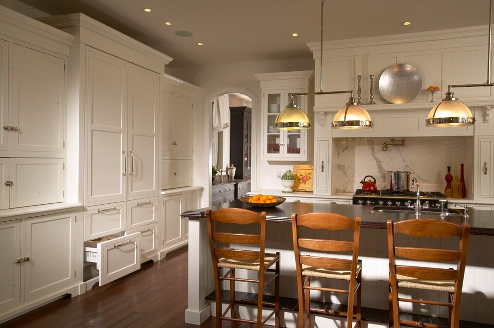 Transitional dark wood floor kitchen photo in Chicago with an undermount sink, shaker cabinets, white cabinets, marble countertops, white backsplash, paneled appliances and an island
