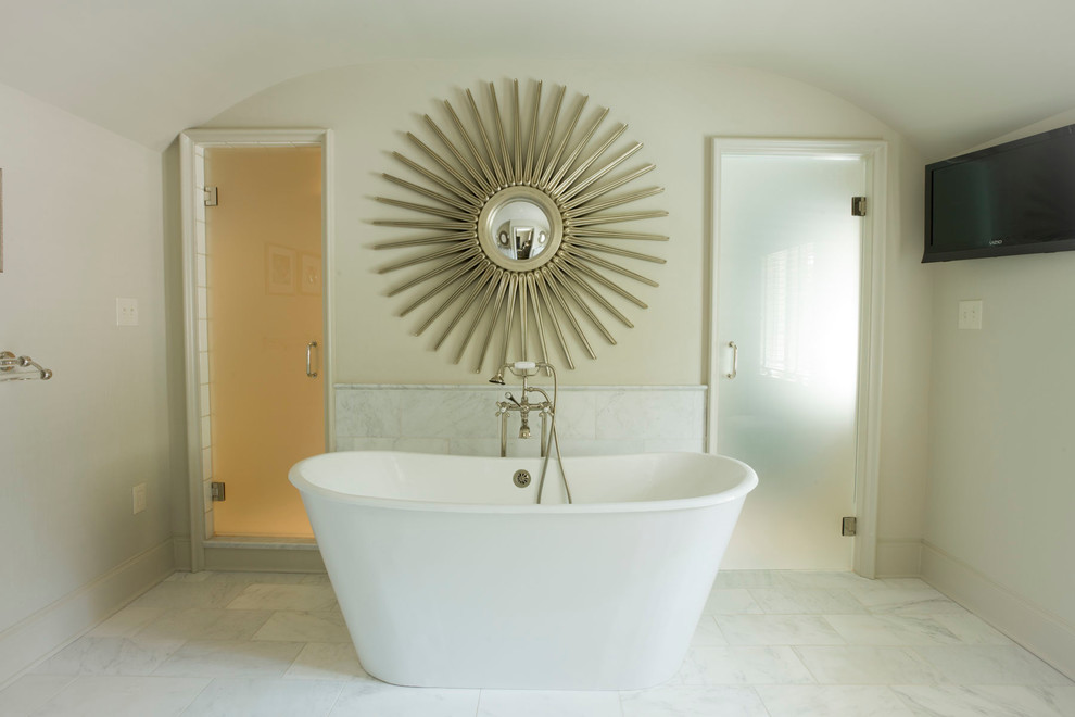 Design ideas for a contemporary bathroom in Charlotte with a freestanding tub and beige walls.