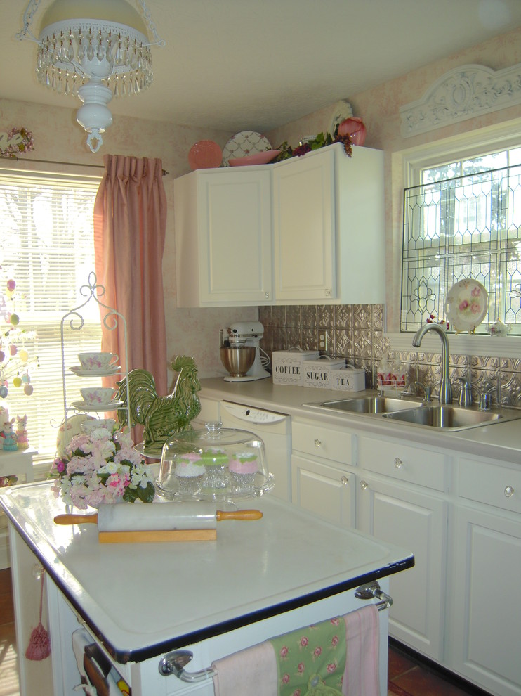This is an example of a traditional kitchen in Other with a drop-in sink, raised-panel cabinets, white cabinets, metallic splashback, metal splashback and white appliances.