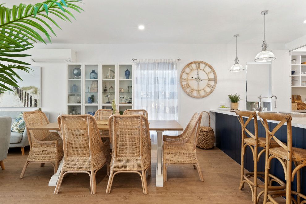 This is an example of a beach style dining room in Sunshine Coast.