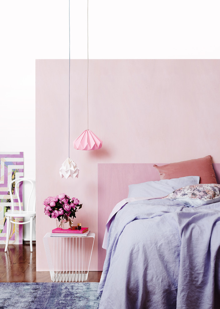 Mid-sized contemporary bedroom in Melbourne with pink walls and dark hardwood floors.