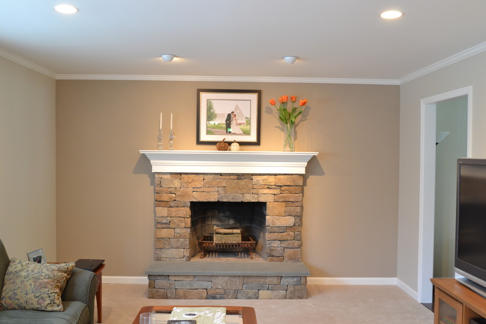 Photo of a mid-sized traditional family room in Philadelphia with beige walls, carpet, a standard fireplace, a stone fireplace surround and a freestanding tv.