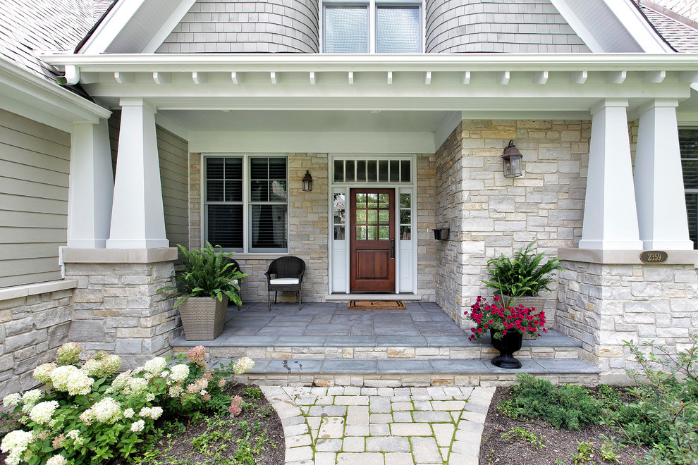 This is an example of a traditional entryway in Chicago with a single front door and a dark wood front door.