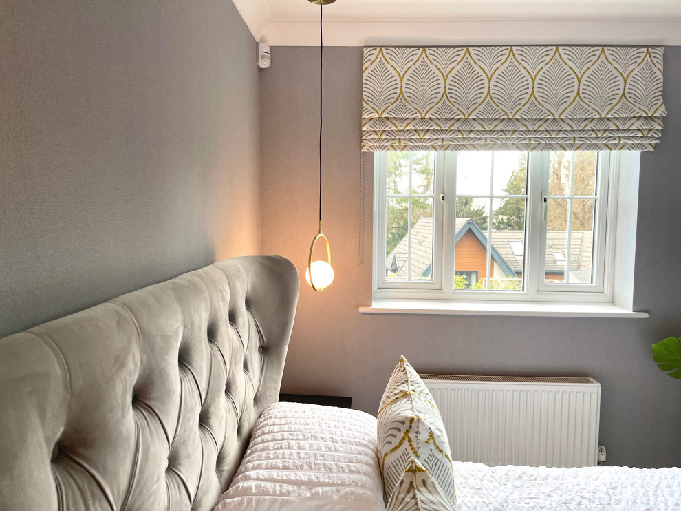 Medium sized contemporary master bedroom in Hertfordshire with grey walls, carpet, grey floors and wallpapered walls.