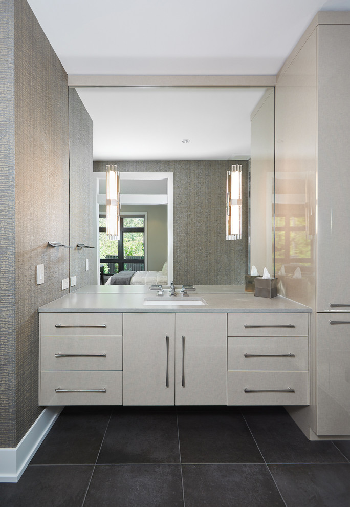 Photo of a large contemporary master bathroom in Grand Rapids with flat-panel cabinets, white cabinets, an undermount sink, engineered quartz benchtops, black floor, grey benchtops, a single vanity, a floating vanity and wallpaper.