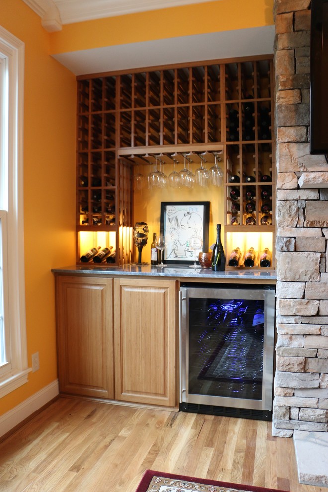 Inspiration for a small traditional home bar in Cincinnati with light hardwood floors.