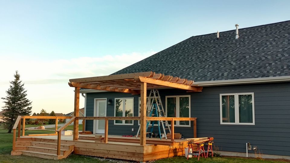 Deck - large rustic deck idea with a pergola