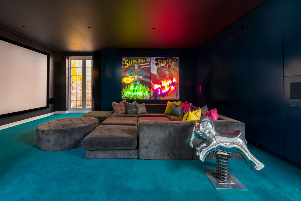 This is an example of an expansive eclectic enclosed home theatre in London with blue walls, carpet and blue floor.
