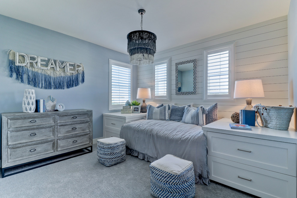This is an example of a transitional bedroom in Orange County with blue walls, carpet and grey floor.