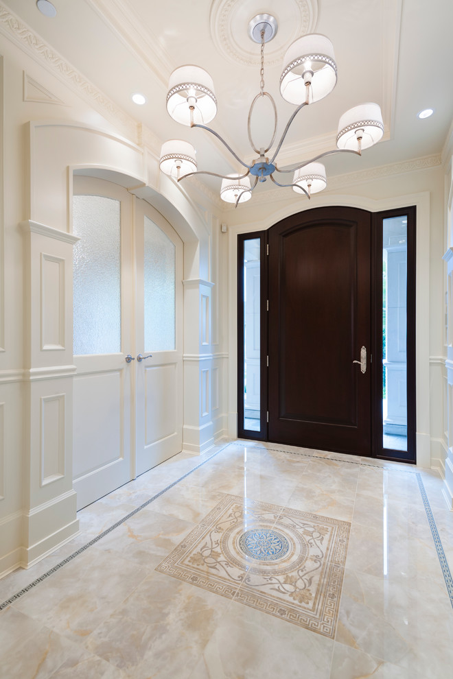 Design ideas for a traditional foyer in Vancouver with white walls, marble floors, a single front door and a dark wood front door.