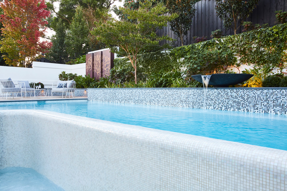 Midcentury backyard custom-shaped pool in Melbourne.