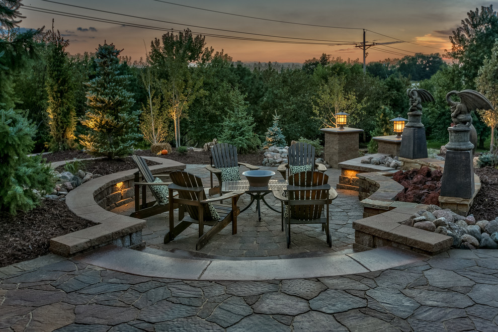 Inspiration for a large backyard patio in Omaha with natural stone pavers.