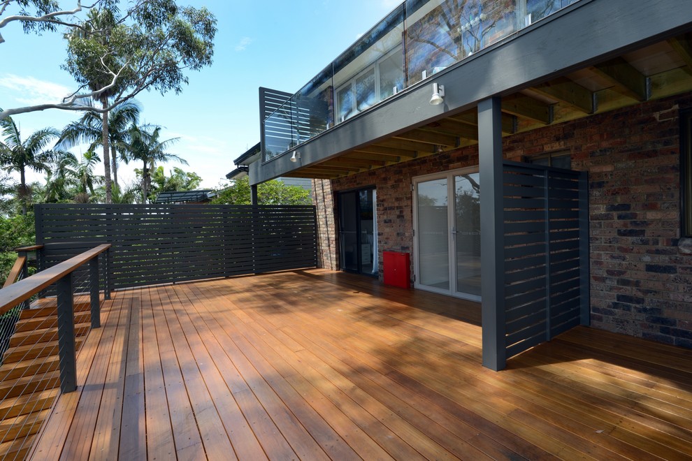 Photo of a large contemporary backyard deck in Sydney.