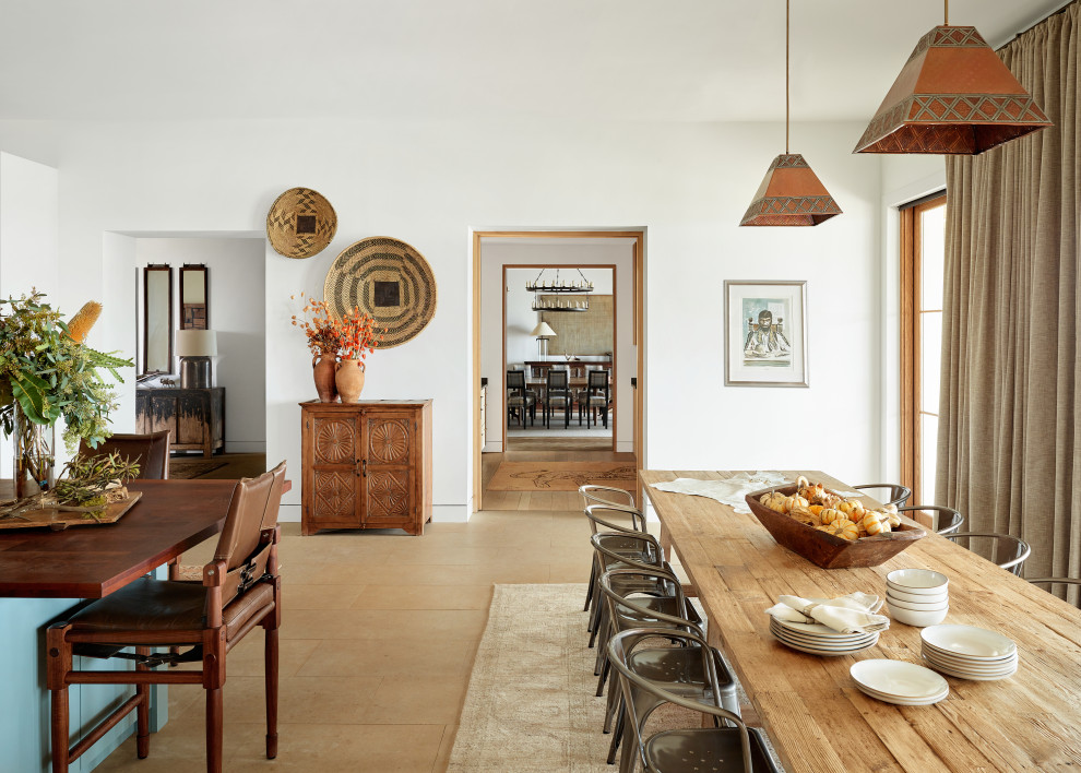 Inspiration for a large rustic single-wall ceramic tile and beige floor kitchen/dining room combo remodel in Austin with flat-panel cabinets, white cabinets, solid surface countertops, gray backsplash, stone slab backsplash, stainless steel appliances, an island and gray countertops