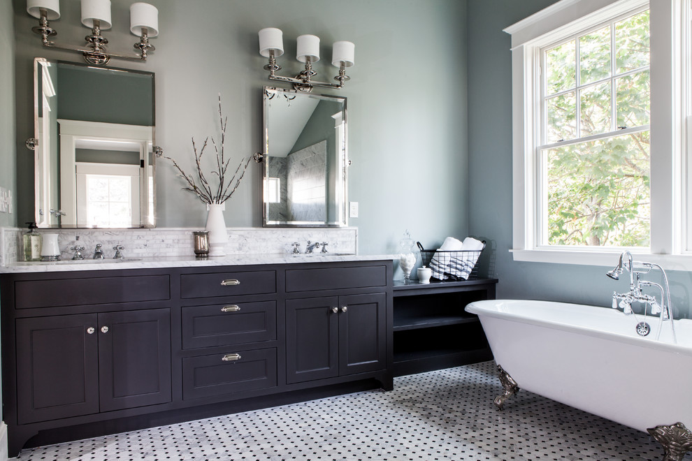 Inspiration for a large contemporary master bathroom in Orange County with shaker cabinets, black cabinets, a claw-foot tub, a two-piece toilet, gray tile, white tile, matchstick tile, blue walls, marble floors, an undermount sink, marble benchtops and grey floor.