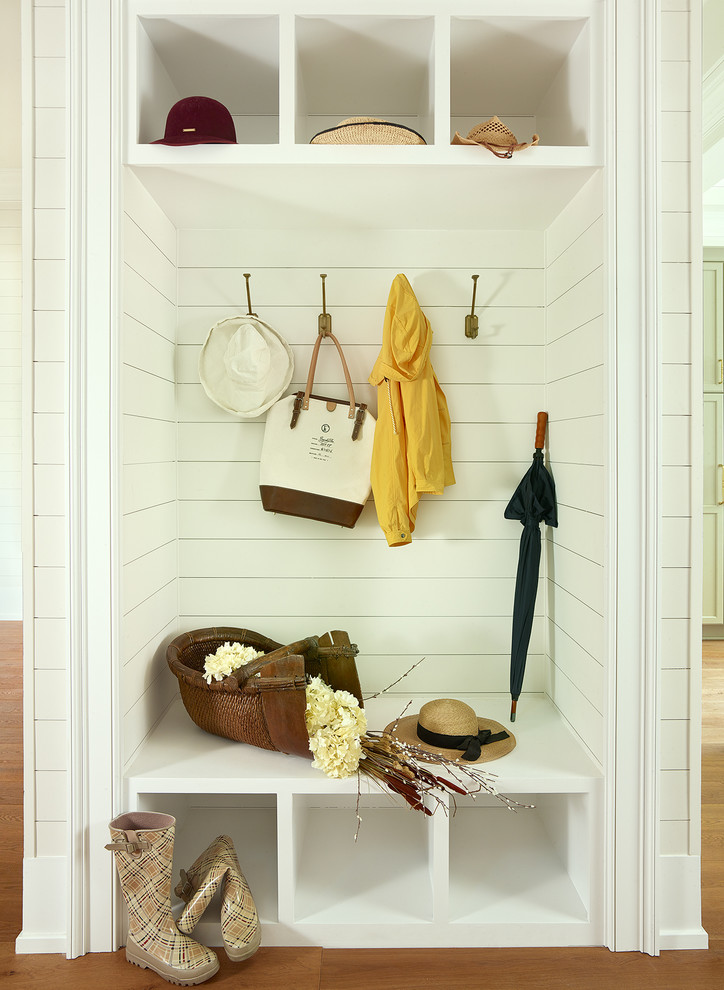 Inspiration for a small traditional mudroom in Charleston with white walls, medium hardwood floors and brown floor.