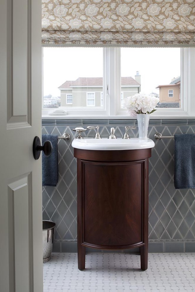 Photo of a traditional bathroom in San Francisco with gray tile and a console sink.
