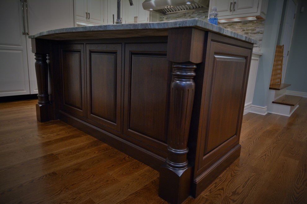 Inspiration for a mid-sized transitional l-shaped dark wood floor eat-in kitchen remodel in Boston with raised-panel cabinets, dark wood cabinets, granite countertops, multicolored backsplash and an island