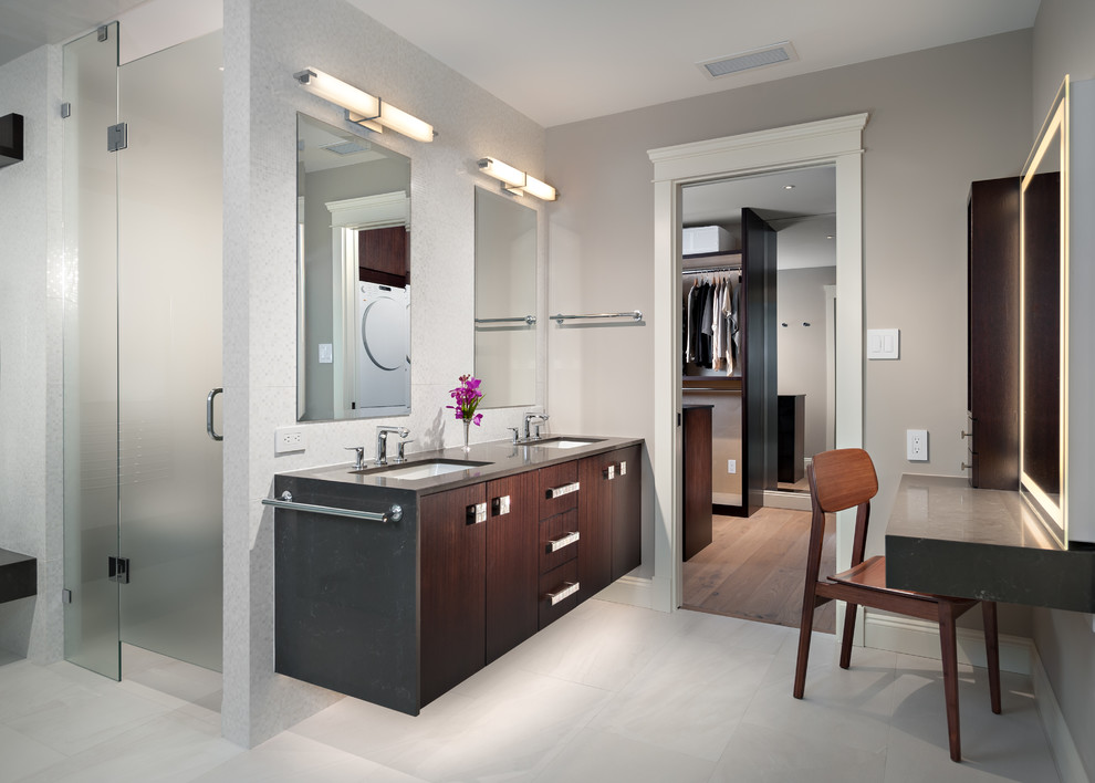 This is an example of a large transitional master bathroom in Vancouver with flat-panel cabinets, dark wood cabinets, a freestanding tub, a curbless shower, granite benchtops, a wall-mount toilet, a console sink, white floor and a hinged shower door.