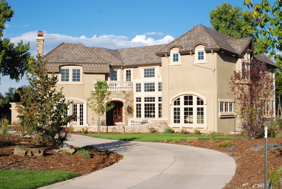 Photo of an expansive traditional two-storey beige exterior in Denver with mixed siding and a hip roof.