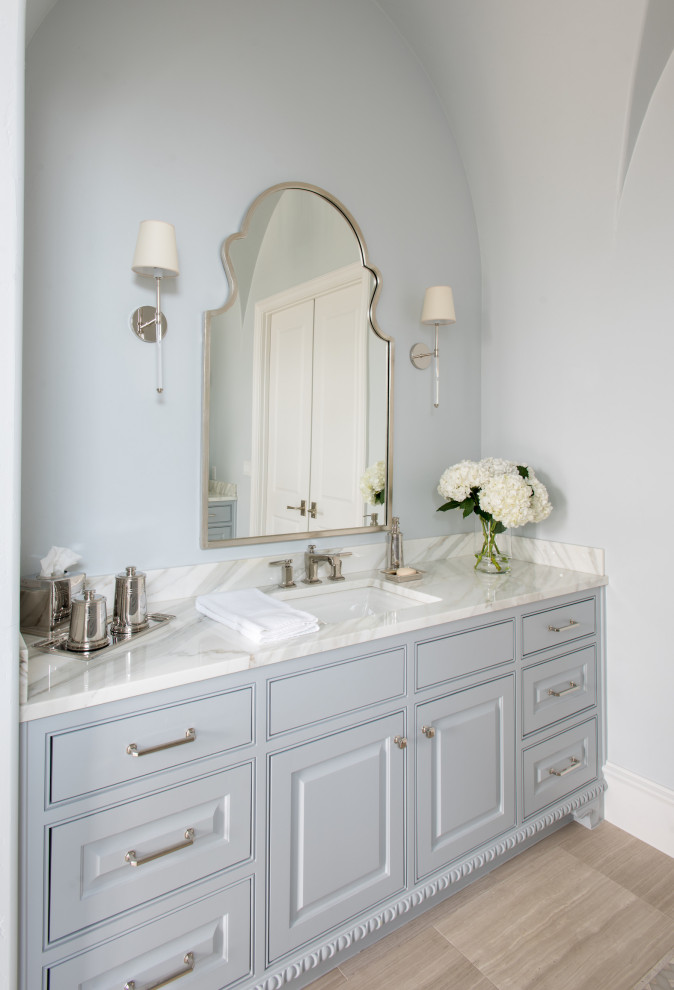 This is an example of a large master bathroom in Dallas with beaded inset cabinets, blue cabinets, blue walls, dark hardwood floors, an undermount sink, marble benchtops, beige floor, white benchtops, a double vanity, a built-in vanity and vaulted.