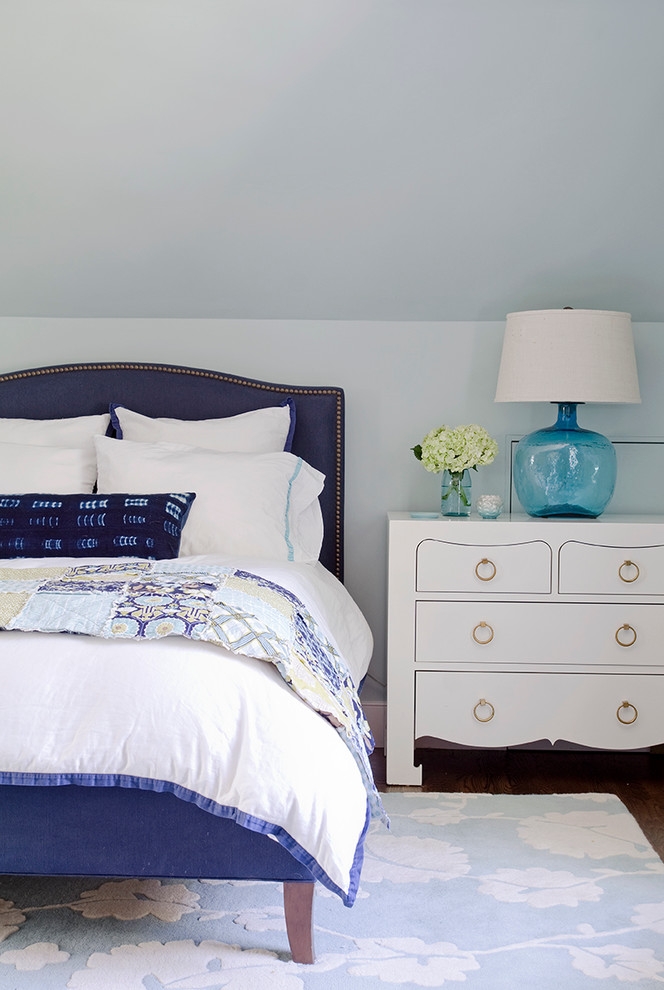Beach style bedroom in Boston with blue walls and dark hardwood floors.