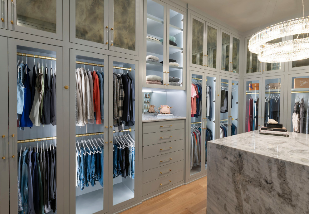 Inspiration for a large contemporary gender-neutral walk-in wardrobe in Dallas with shaker cabinets, grey cabinets, light hardwood floors and beige floor.