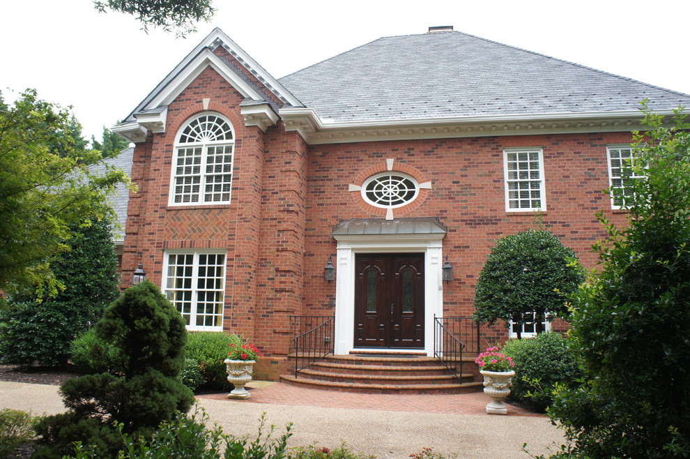 Inspiration for a large traditional two-storey brick red exterior in Richmond.
