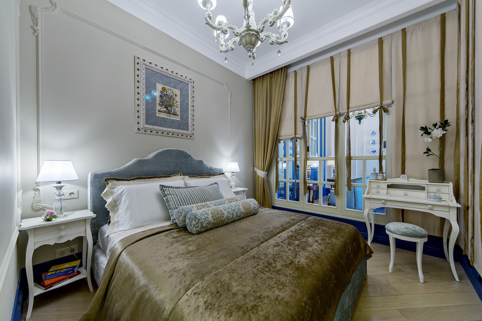 Inspiration for a traditional master bedroom in Moscow with grey walls and light hardwood floors.