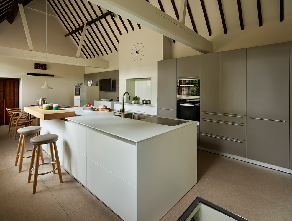 Design ideas for a large contemporary single-wall eat-in kitchen in Other with an integrated sink, flat-panel cabinets, white cabinets, laminate benchtops, white splashback, glass sheet splashback, black appliances, porcelain floors and with island.