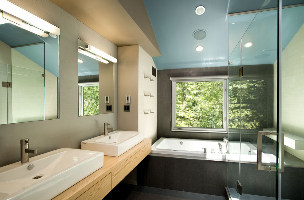 Inspiration for a contemporary bathroom in DC Metro with a vessel sink and a drop-in tub.