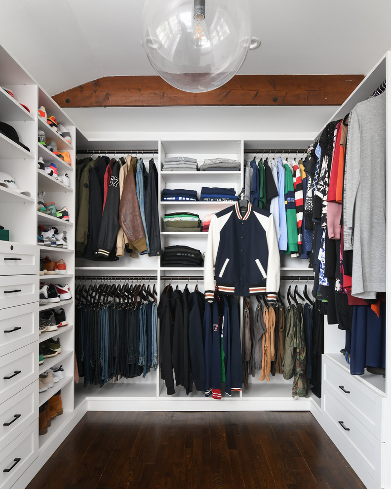 Design ideas for a large transitional gender-neutral walk-in wardrobe in New York with white cabinets, brown floor, open cabinets and dark hardwood floors.
